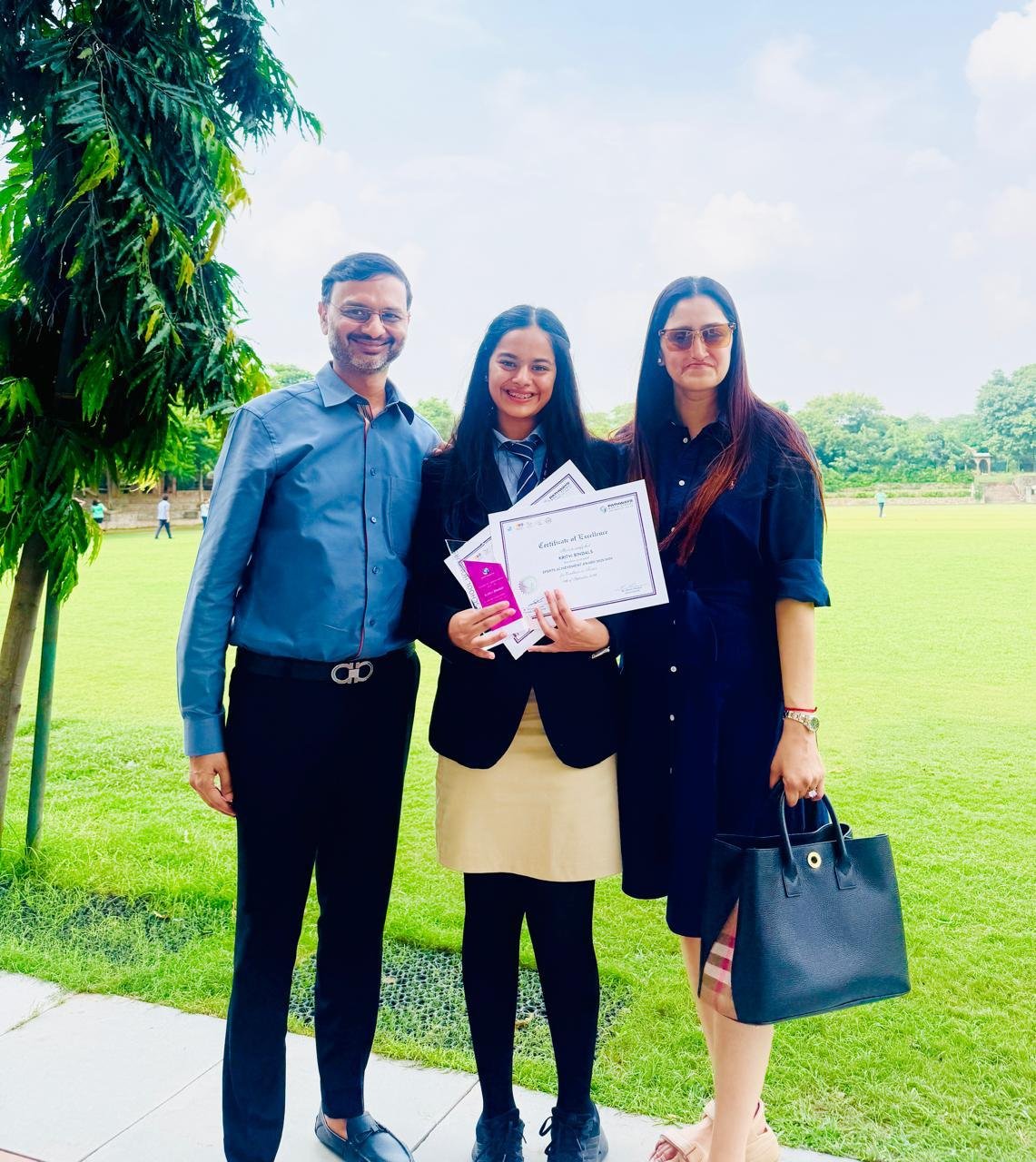 Kritvi Bindals with her parents Ankur Bindals and Sanya Bindals after an achievement